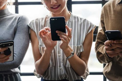 Three people using their mobile phones